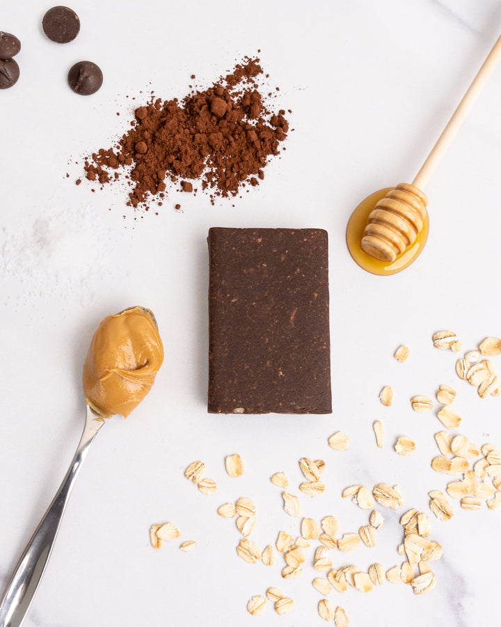 chocolate bar cocoa powder peanut butter honey oats white background