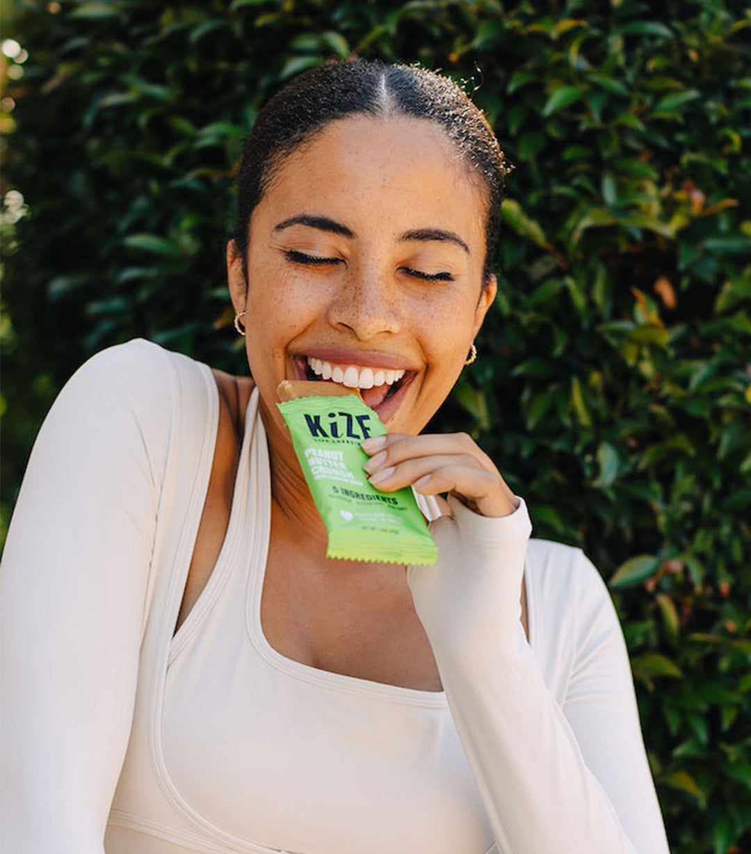 Girl smiling eating Kize Bar