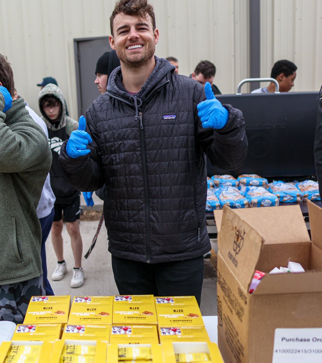 man showing thumbs up in packing facility