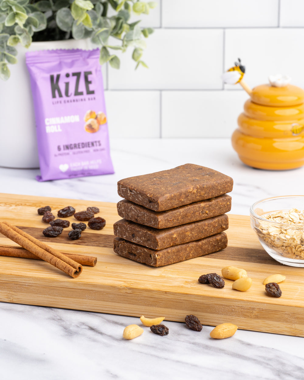 Kize Cinnamon Roll Protein Bars Stacked on Kitchen Counter